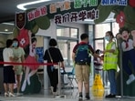 Men wearing face masks rest outside a closed China Telecom store in Huaqiangbei, the world's largest electronics market, following the coronavirus disease (Covid-19) outbreak in Shenzhen, Guangdong province, China.&nbsp;(REUTERS/David Kirton)
