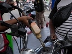 An attendant fills up the tank of a motorbike at a gasoline station in Jakarta, Indonesia. An attendant fills up the tank of a motorbike at a gasoline station in Jakarta, Indonesia.