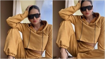 Sunny decked up in a cropped ochre hoodie and a pair of ochre trousers and looked super cool in the outfit. (Instagram/@sunnyleone)