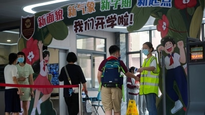 Men wearing face masks rest outside a closed China Telecom store in Huaqiangbei, the world's largest electronics market, following the coronavirus disease (Covid-19) outbreak in Shenzhen, Guangdong province, China.&nbsp; (REUTERS/David Kirton)