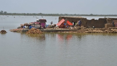 A family sit under a tent in their damaged home surrounded by flood, in Jaffarabad, a district of Pakistan's southwestern Baluchistan province, Saturday. (AP) A family sit under a tent in their damaged home surrounded by flood, in Jaffarabad, a district of Pakistan's southwestern Baluchistan province, Saturday. (AP)