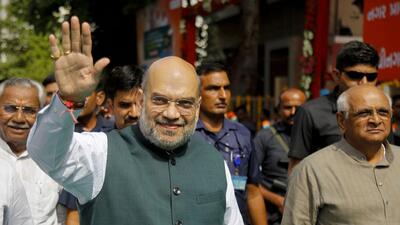 Union home Minister Amit Shah waves at supporters during inauguration of Gandhinagar Anupam Smart Primary School in Ahmedabad on Sunday. (PTI)