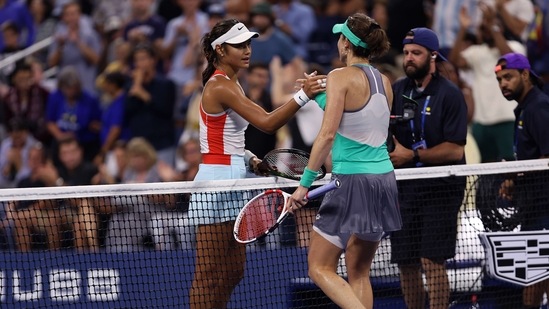 Alize Cornet of France is congratulated by Emma Raducanu of Great Britain after their Women's Singles First Round match on Day Two of the 2022 US Open