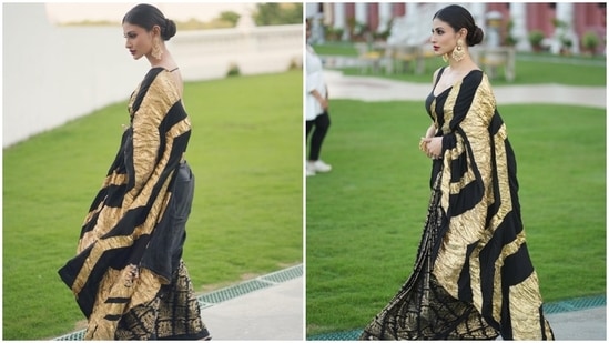 The pre-pleated crepe saree comes in a solid black shade and features black crinkle pallu with gold foil work, ruffle additions on the border, gold embroidery done in a flock of bird patterns, and tassels adorned on the ends.(Instagram)