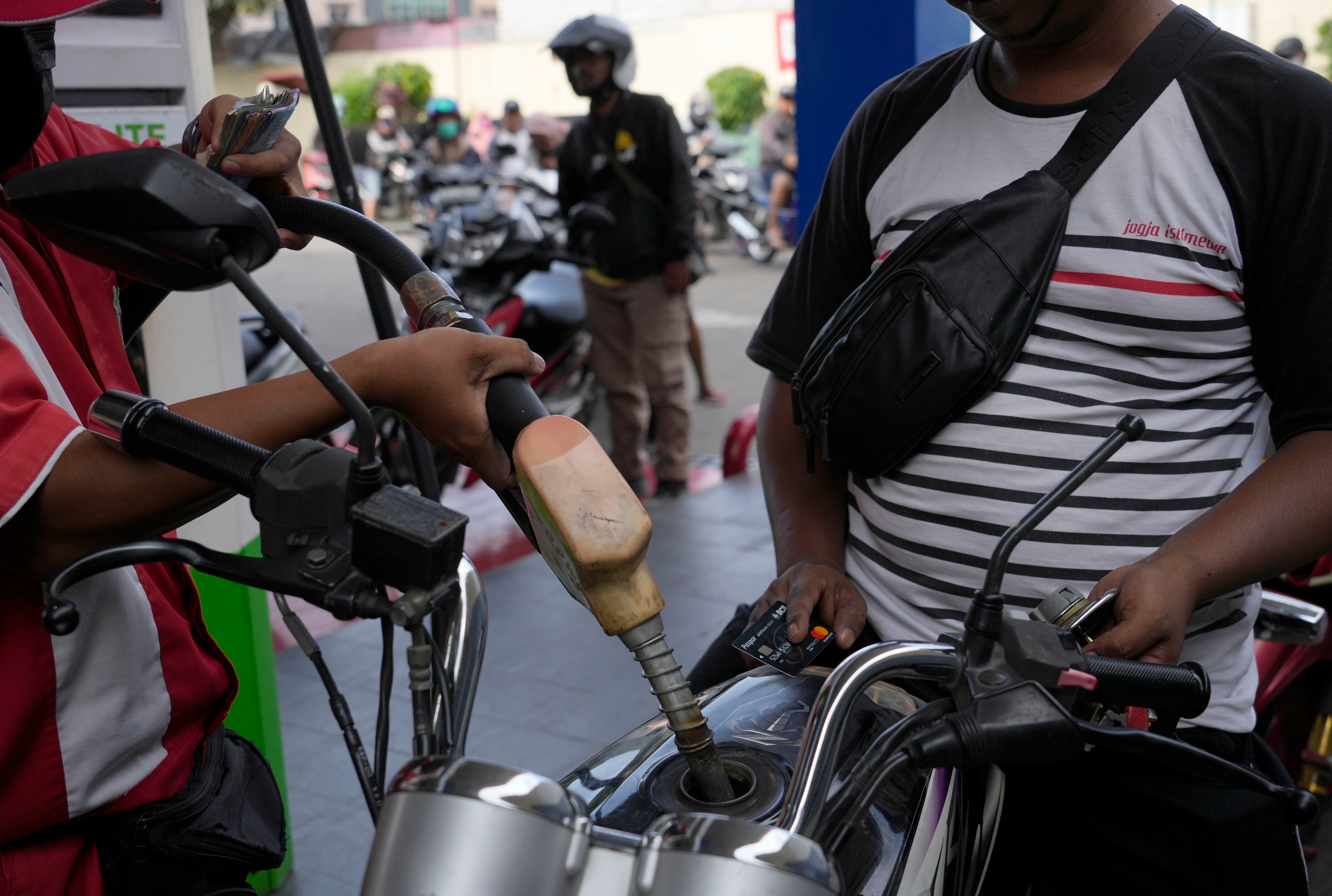 An attendant fills up the tank of a motorbike at a gasoline station in Jakarta, Indonesia. (AP) An attendant fills up the tank of a motorbike at a gasoline station in Jakarta, Indonesia. (AP)