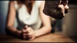 Young woman is sitting hunched at a table at home, the focus is on a man's fist in the foregound of the image (Getty Images/iStockphoto) Young woman is sitting hunched at a table at home, the focus is on a man's fist in the foregound of the image (Getty Images/iStockphoto)