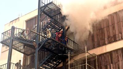 Fumes billow out as firefighters carry out a rescue operation after a fire broke out at a hotel, at Hazratganj, in Lucknow on Monday. (ANI PHOTO) Fumes billow out as firefighters carry out a rescue operation after a fire broke out at a hotel, at Hazratganj, in Lucknow on Monday. (ANI PHOTO)