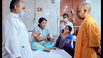 UP CM Yogi Adityanath visits injured at Dr. Shyama Prasad Mukherjee (Civil) Hospital to know their well being, after a fire broke out at a Lucknow hotel. (PTI Photo)