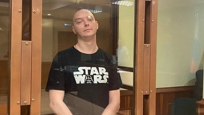 Ivan Safronov, a former journalist and an aide to the head of Russia's space agency Roscosmos who remains in custody on state treason charges, stands inside a defendants' cage as he attends a court hearing in Moscow. Ivan Safronov, a former journalist and an aide to the head of Russia's space agency Roscosmos who remains in custody on state treason charges, stands inside a defendants' cage as he attends a court hearing in Moscow.