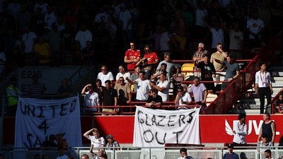 Manchester United fans display banners in protest of the Glazer family’s ownership of the club. (REUTERS)