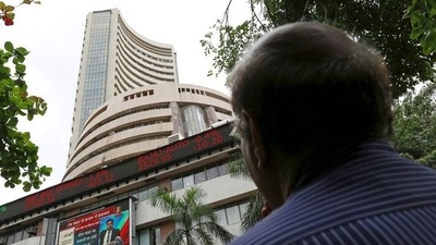 A man looks at a screen across a road displaying the Sensex on the facade of the Bombay Stock Exchange (BSE) building in Mumbai, India. (File image) (REUTERS)