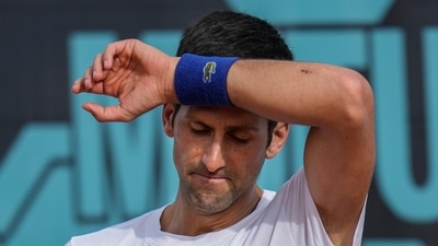 Novak Djokovic, of Serbia, wipes the sweat off during a training session at the Mutua Madrid Open tennis tournament in Madrid, Spain, on April 30, 2022 (AP)