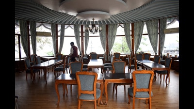 A worker set the chairs in the empty restaurant of Himachal Pradesh tourism department in Shimla. (HT File)