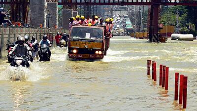 Commuters wade through a waterlogged road following incessant rain at the Marathalli Outer Ring Road (ORR), in Bengaluru on Monday. (ANI) Commuters wade through a waterlogged road following incessant rain at the Marathalli Outer Ring Road (ORR), in Bengaluru on Monday. (ANI)