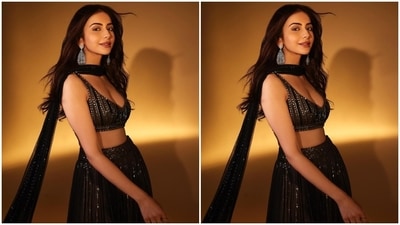 Rakul wore the blouse piece with a matching black tulle lehenga embroidered with shimmering silver sequins, layered and pleated ghera, a heavily embellished waistband, and a floor-grazing hem length. (Instagram) Rakul wore the blouse piece with a matching black tulle lehenga embroidered with shimmering silver sequins, layered and pleated ghera, a heavily embellished waistband, and a floor-grazing hem length. (Instagram)