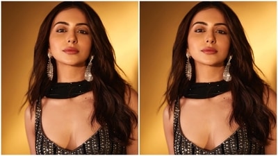 Rakul's lehenga set features a sleeveless bralette adorned with shimmering metallic diamantes decorated in various patterns. It has a short hem length flaunting the star's toned midriff and a plunging V neckline accentuating her décolletage. (Instagram) Rakul's lehenga set features a sleeveless bralette adorned with shimmering metallic diamantes decorated in various patterns. It has a short hem length flaunting the star's toned midriff and a plunging V neckline accentuating her décolletage. (Instagram)