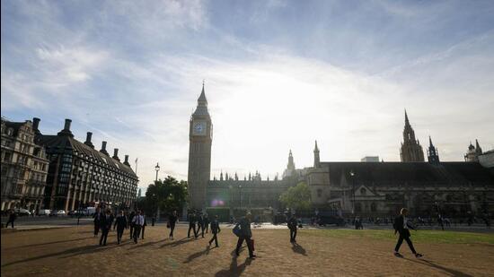 Morning commuters cross parliament square near the Houses of Parliament on the day of the announcement of the new leader of the ruling Conservative Party in London, UK, on Monday. (Bloomberg)