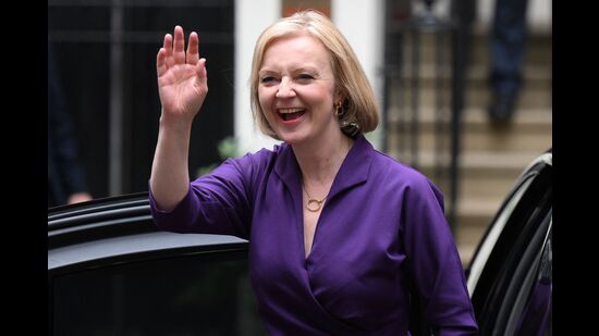 New Conservative Party leader and incoming prime minister Liz Truss smiles and waves as she arrives at Conservative Party Headquarters in central London having been announced the winner of the leadership contest September 5, 2022 (AFP)