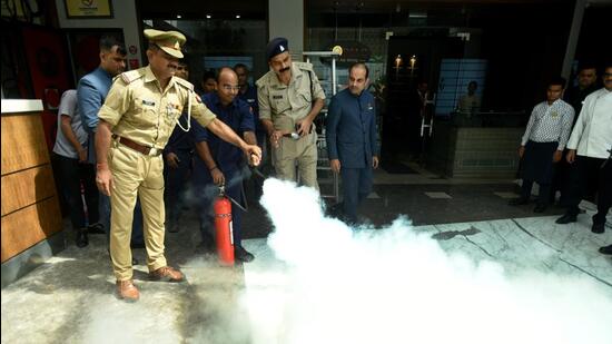 The Gautam Budh Nagar fire department conducted mock drills (in photo) and issued notices to eight buildings for not having fire safety measures in place, said officials. (Sunil Ghosh /HT Photo)