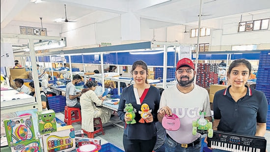 Jitender Singh with his daughters at their toy manufacturing unit in Kundli. (HT Photo)