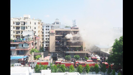 Firefighters trying to douse fire at hotel Levana at Hazratganj in Lucknow Monday. (Deepak Gupta/HT photo)