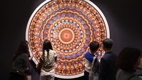 Visitors look at artwork "High Windows (Happy Life), 2006" by artist Damien Hirst during the Frieze Seoul 2022 art fair in Seoul on September 2, 2022. -(AFP)