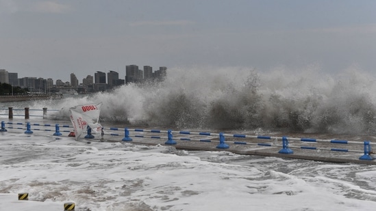 Waves generated by Typhoon Hinnamnor break along the coast in Qingdao in China's eastern Shandong province on Monday.(AFP)