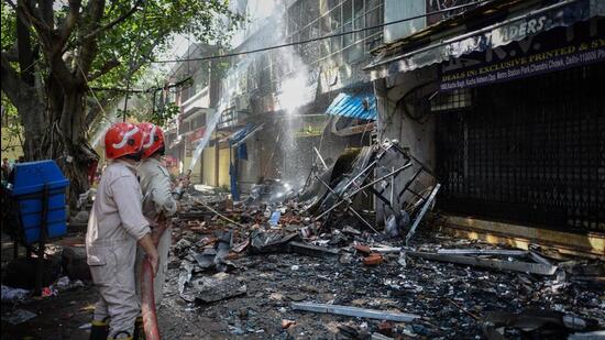 Most of the shops and godowns in the commercial building were being used as warehouses for clothes, officials said. (Sanchit khanna/HT Photo)