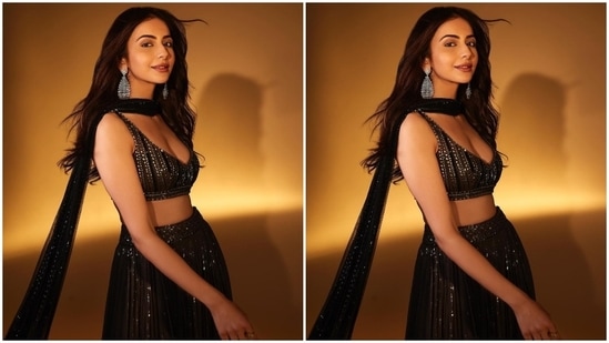 Rakul wore the blouse piece with a matching black tulle lehenga embroidered with shimmering silver sequins, layered and pleated ghera, a heavily embellished waistband, and a floor-grazing hem length.(Instagram)