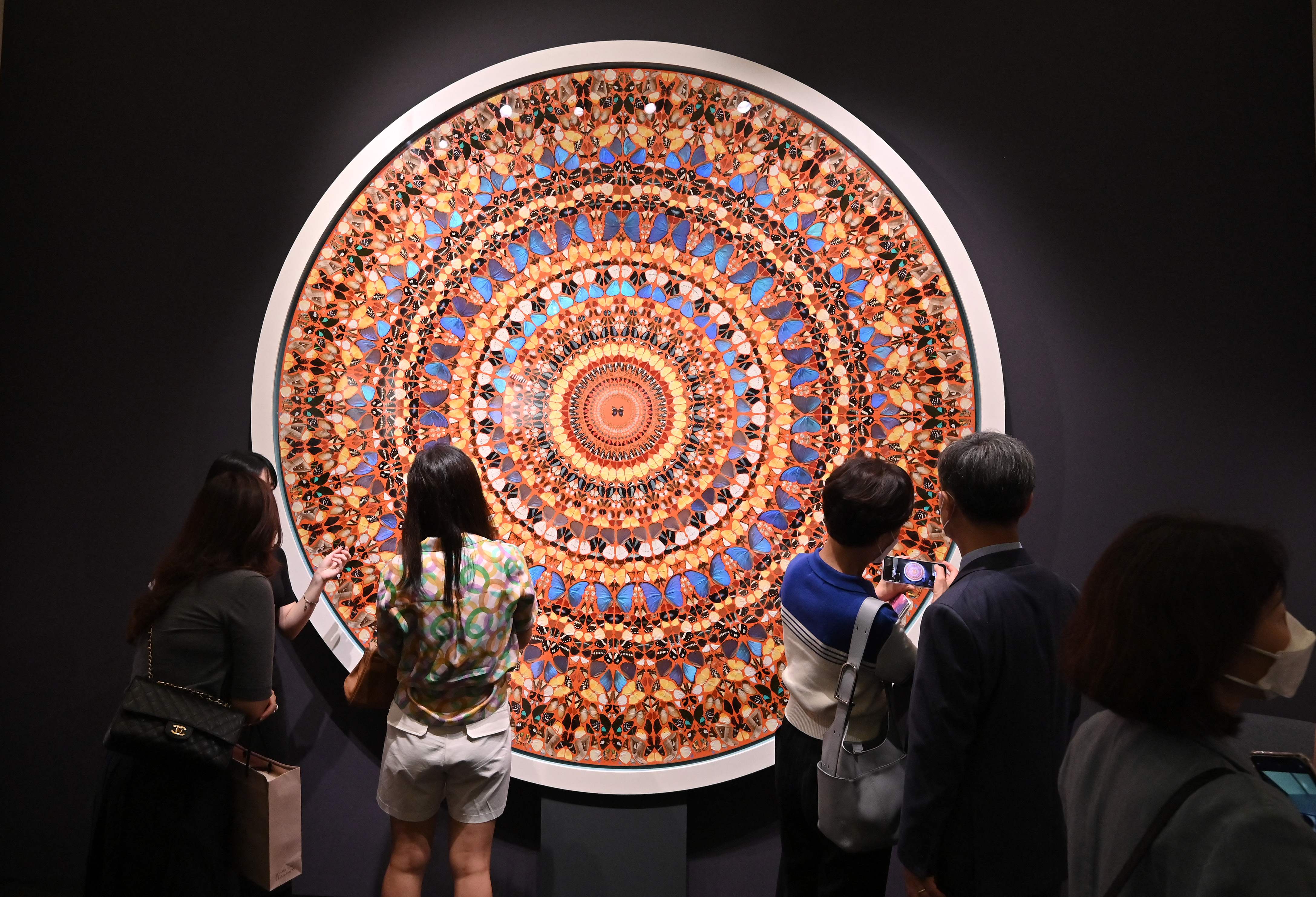 Visitors look at artwork "High Windows (Happy Life), 2006" by artist Damien Hirst during the Frieze Seoul 2022 art fair in Seoul on September 2, 2022. - (AFP) Visitors look at artwork "High Windows (Happy Life), 2006" by artist Damien Hirst during the Frieze Seoul 2022 art fair in Seoul on September 2, 2022. - (AFP)