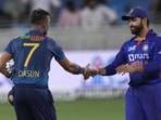 India's captain Rohit Sharma, right, shake hands with Sri Lanka's captain Dasun Shanaka to congratulate him(AP)