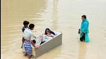 Residents of a waterlogged locality try to reach a safer place with making sit their children in a fridge following heavy rains, in Bengaluru on Tuesday (ANI) Residents of a waterlogged locality try to reach a safer place with making sit their children in a fridge following heavy rains, in Bengaluru on Tuesday (ANI)