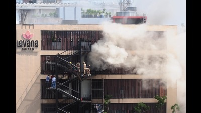 Firefighter trying to douse fire at hotel Levana at Hazratganj in Lucknow on Monday. (Deepak Gupta/HT PHOTO)