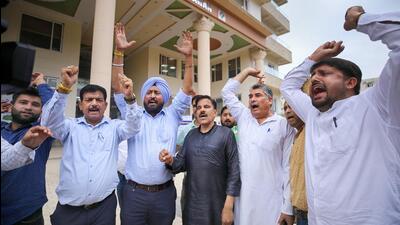 Aam Aadmi Party activists staged a protest outside the J&K election commission’s office in Jammu. (PTI)