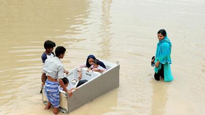 Residents of a waterlogged locality try to reach a safer place with making sit their children in a fridge following heavy rains, in Bengaluru on Tuesday (ANI) Residents of a waterlogged locality try to reach a safer place with making sit their children in a fridge following heavy rains, in Bengaluru on Tuesday (ANI)