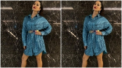 Sunny decked up in a shimmery blue shirt dress featuring collars and full sleeves. The dress also came with a silver belt detail at the waist. (Instagram/@sunnyleone)