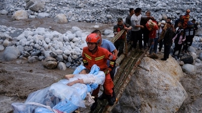 China Sichuan Earthquake: Rescue workers carry an injured victim on a stretcher following a 6.8-magnitude earthquake. (Reuters)