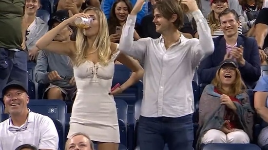 Megan Lucky chugs her beer at the US Open.(Twitter)