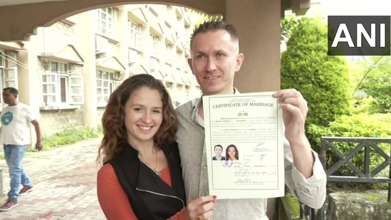 The newly married couple with their marriage certificate in Dharamshala, Himachal Pradesh.&nbsp;