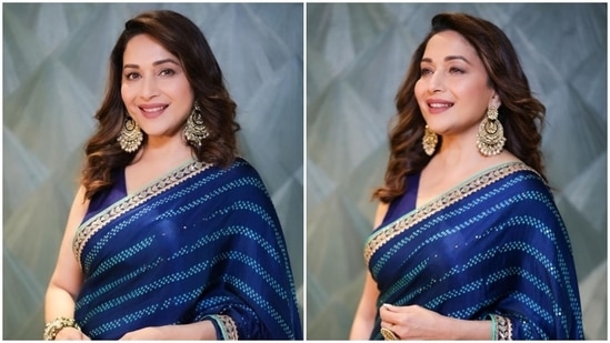 Madhuri Dixit displays her timeless grace in this blue saree and sleeveless blouse. She paired her look with huge chandbalis.(Instagram/@madhuridixitnene)