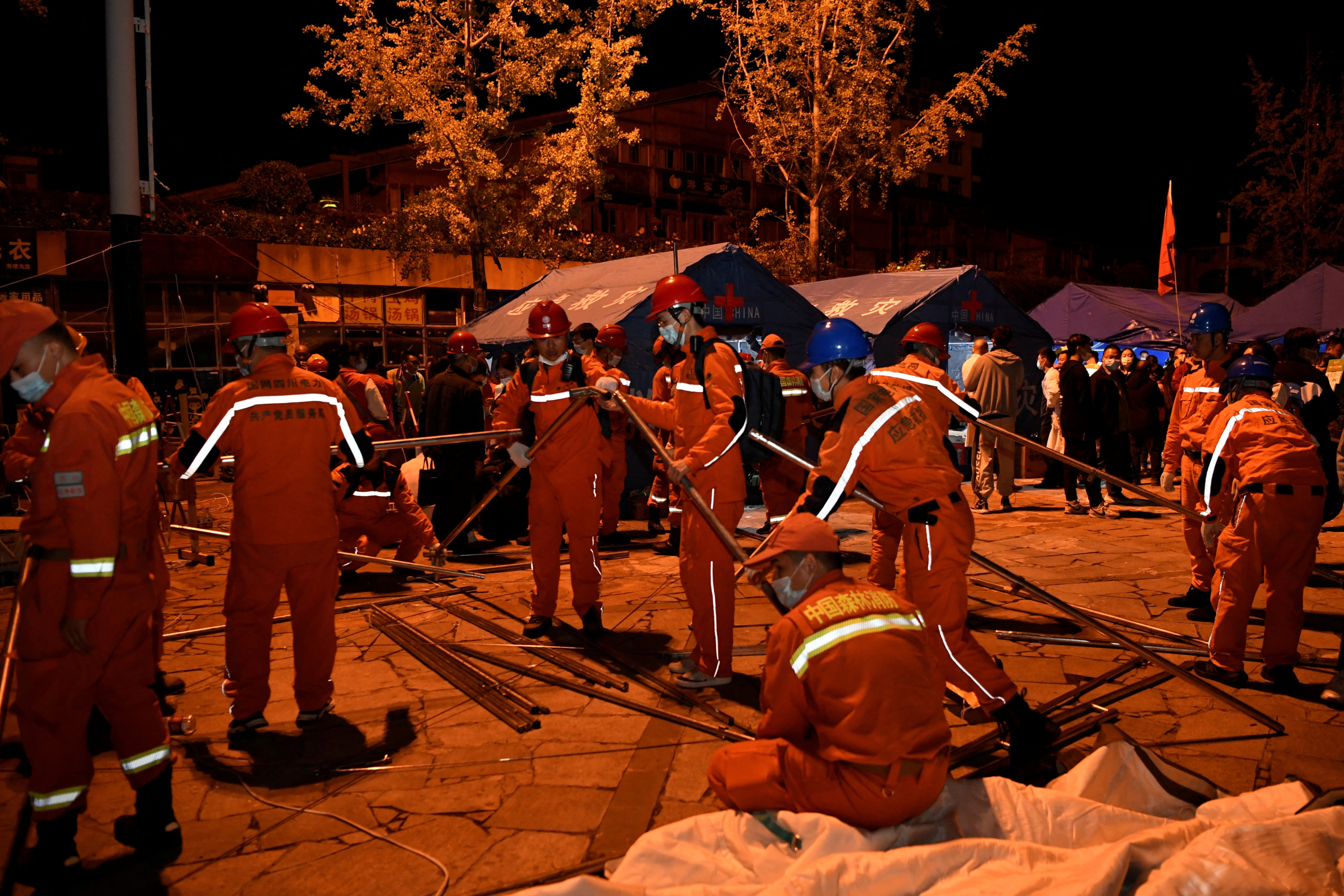 China Sichuan Earthquake: Rescue workers set up tents at a shelter following a 6.8-magnitude earthquake in Moxi town.&nbsp; (Reuters)