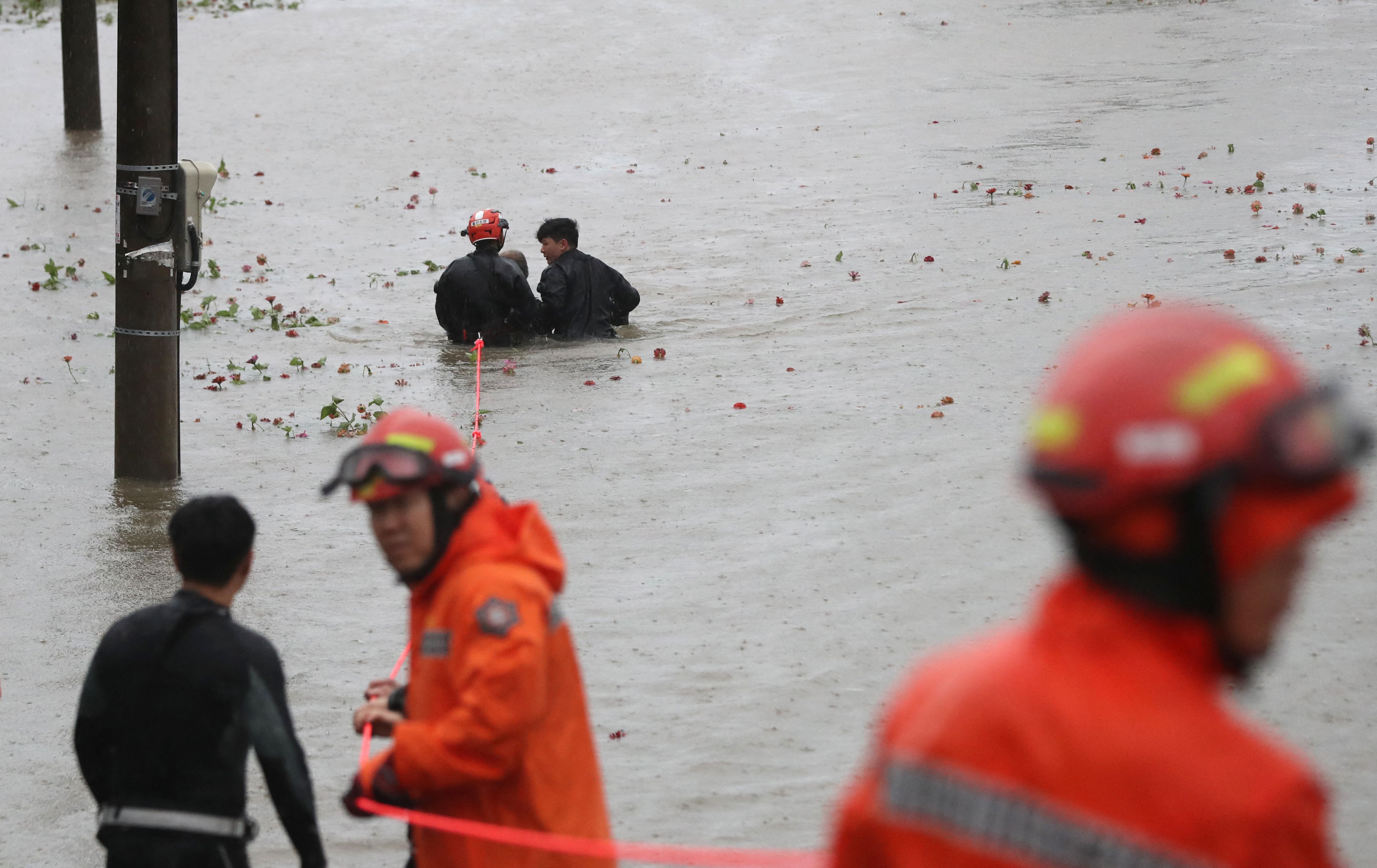 South Korea Super Typhoon Hinnamnor: South Korean rescue workers rescue a man from a flooded riverside park. (AFP) South Korea Super Typhoon Hinnamnor: South Korean rescue workers rescue a man from a flooded riverside park. (AFP)