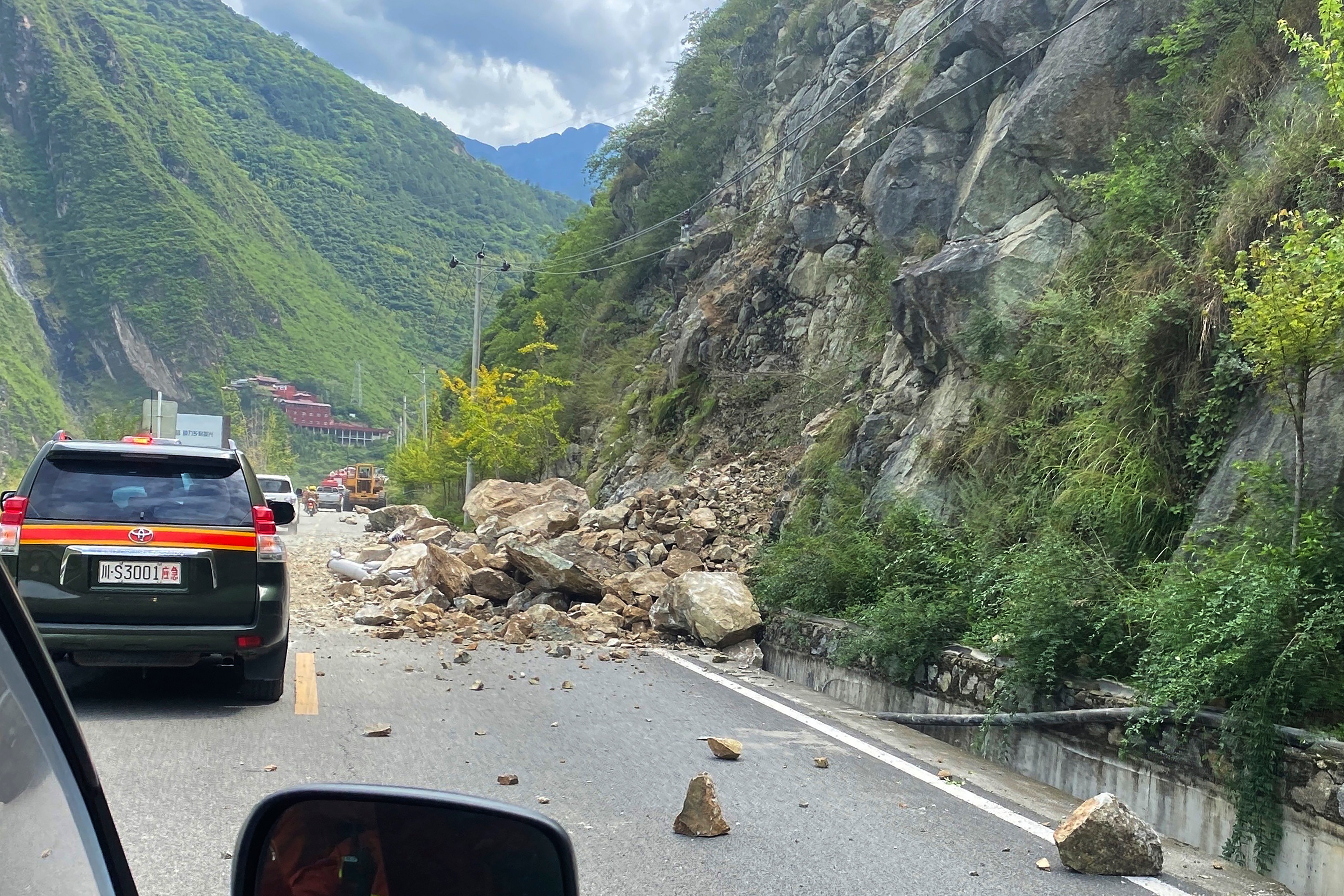 China Sichuan Earthquake: Fallen rocks are seen on road heading to Luding county in China. (AP) China Sichuan Earthquake: Fallen rocks are seen on road heading to Luding county in China. (AP)