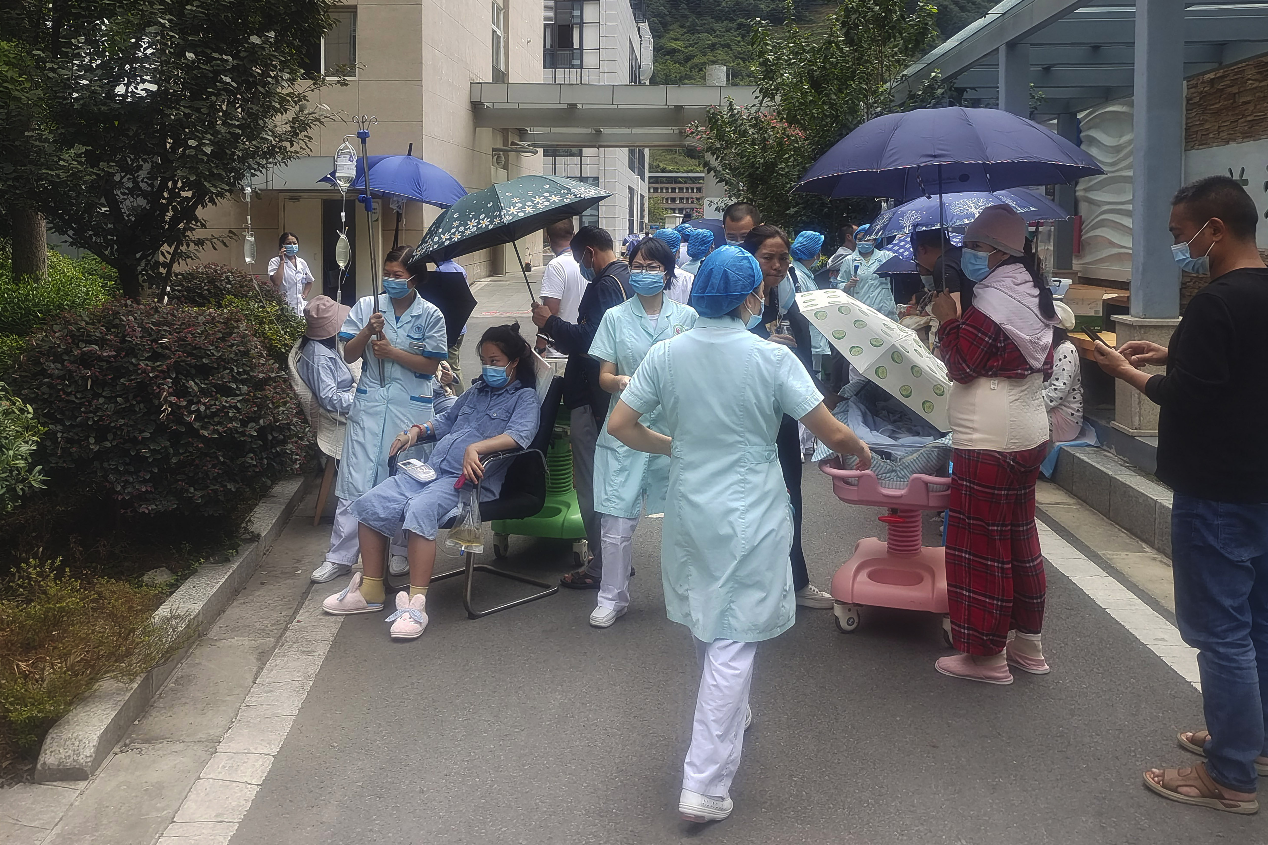 China Sichuan Earthquake: Medical workers transfer patients to safe area in Ya'an City. (AP) China Sichuan Earthquake: Medical workers transfer patients to safe area in Ya'an City. (AP)