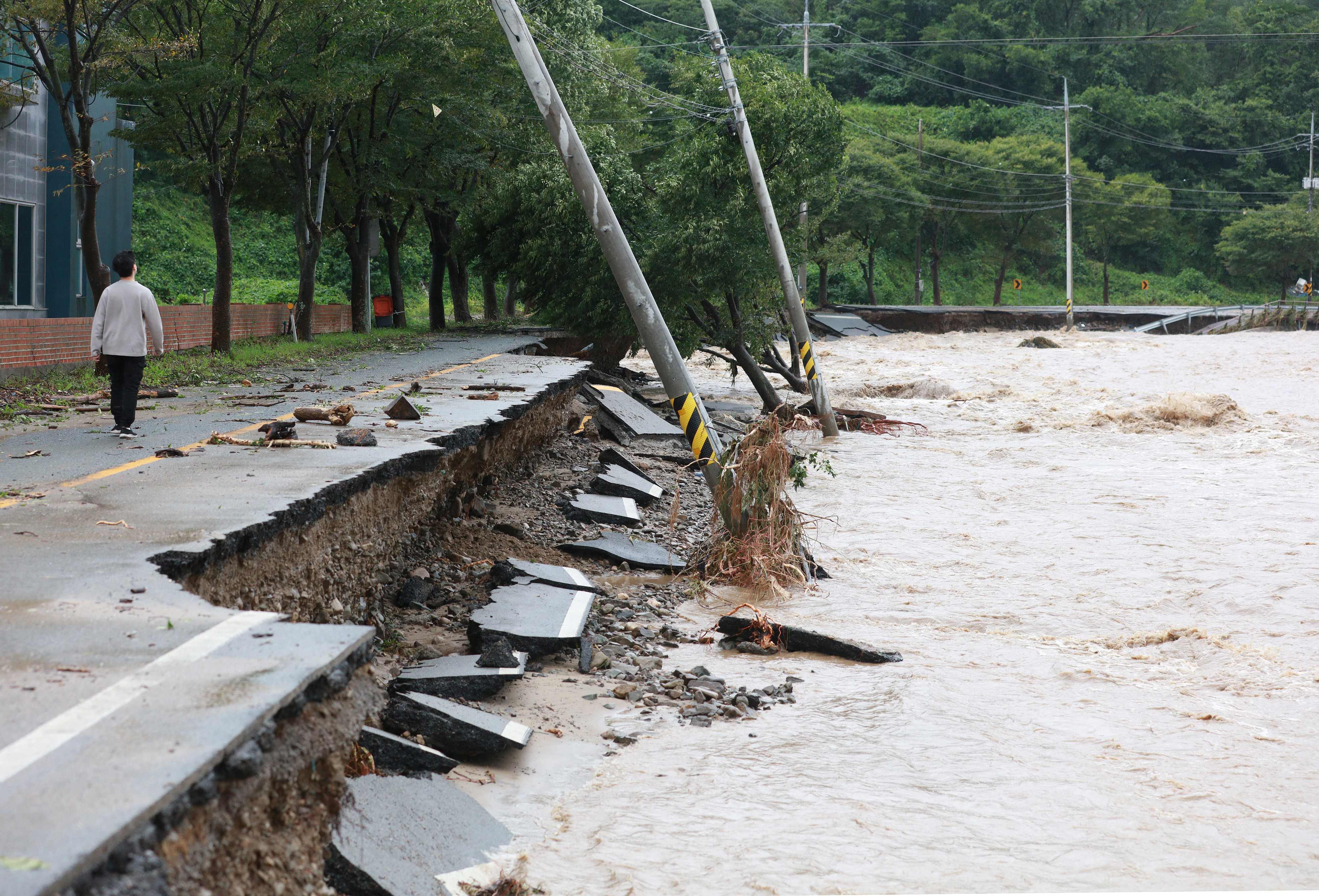 South Korea Super Typhoon Hinnamnor: A man walks along a damaged road in Gyeongju. (AFP) South Korea Super Typhoon Hinnamnor: A man walks along a damaged road in Gyeongju. (AFP)
