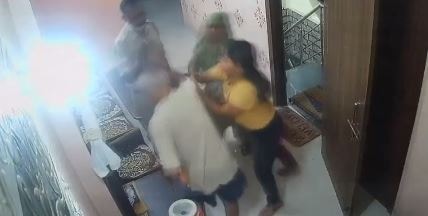 A colleague of the Delhi Police sub-inspector, present at the spot, comes to the rescue of the elderly man and contains the situation. (ANI screengrab)