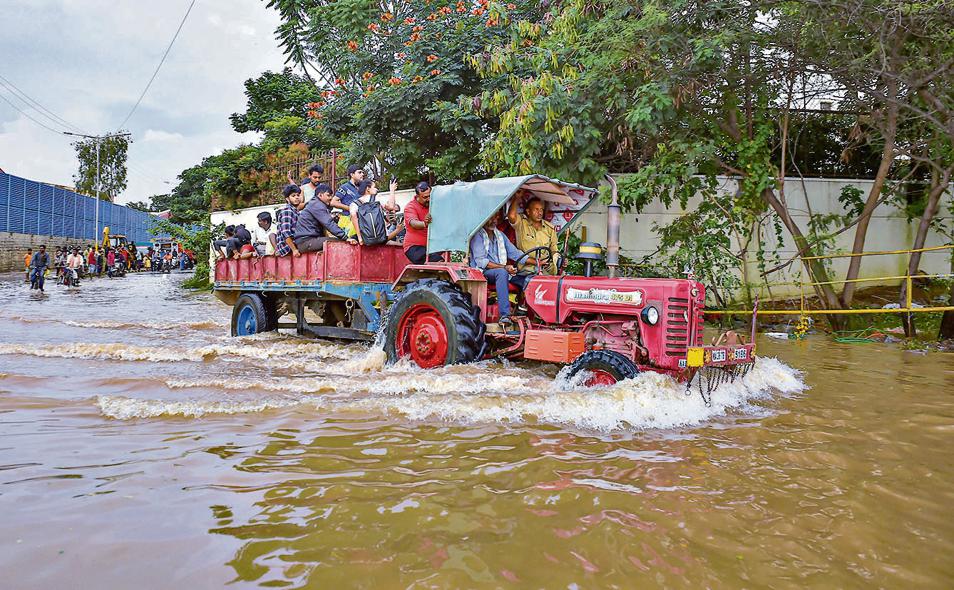 A tractor being used to evacuate people stranded at the waterlogged Yemalur area after heavy monsoon rains, in Bengaluru, Tuesday, September 6, 2022. (PTI Photo/Shailendra Bhojak) A tractor being used to evacuate people stranded at the waterlogged Yemalur area after heavy monsoon rains, in Bengaluru, Tuesday, September 6, 2022. (PTI Photo/Shailendra Bhojak)