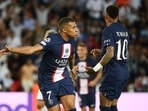 Paris Saint-Germain's French forward Kylian Mbappe (L) celebrates scoring the 2-0 goal with Paris Saint-Germain's Brazilian forward Neymar (R) during the UEFA Champions League Group H first leg football match between Paris Saint-Germain (PSG) and Juventus at Parc des Princes Stadium in Paris