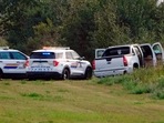 Police and investigators are seen at the side of the road outside Rosthern, Saskatchewan on Wednesday, September 7, 2022. (Kelly Geraldine Malone/The Canadian Press via AP)
