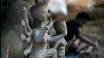 An artisan clays an idol of the Hindu Goddess Durga at a workshop ahead of Durga Puja festival in New Delhi (AFP) An artisan clays an idol of the Hindu Goddess Durga at a workshop ahead of Durga Puja festival in New Delhi (AFP)